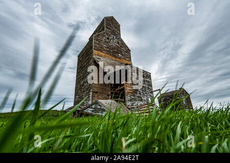 Weathered grain elevator on the prairies; Saskatchewan, Canada Stock Photo