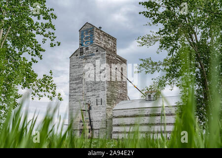 Weathered grain elevator on the prairies; Saskatchewan, Canada Stock Photo