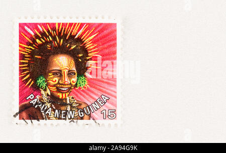 SEATTLE WASHINGTON - October 5, 2019: Papua New Guinea postage stamp with woman in traditional headdress, issue in 1977 Stock Photo