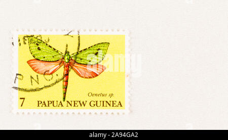 SEATTLE WASHINGTON - October 5, 2019: Papua New Guinea postage stamp featuring flying insect of the Oenetus genus - Aenetus moth.  Scott # 503 Stock Photo