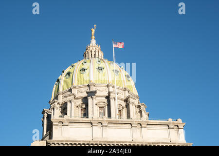 Capitol building, Harrisburg, Pennsylvania with American flag flying against a blue sky.