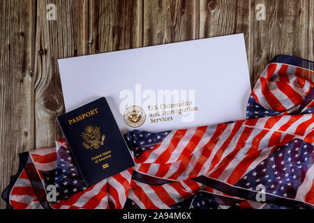 USA passport and citizenship naturalization certificate of US flag over wooden background Stock Photo