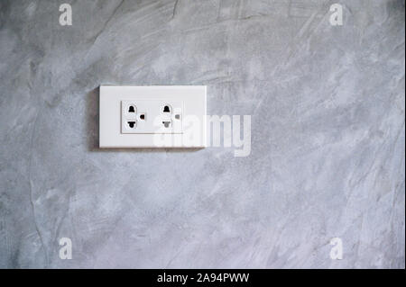 outlet Power saving Hand inserting electrical plug into outlet Stock Photo