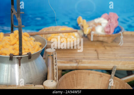 yellow silkworm cocoon shell for making thread producing Thai silk fabric textile Stock Photo