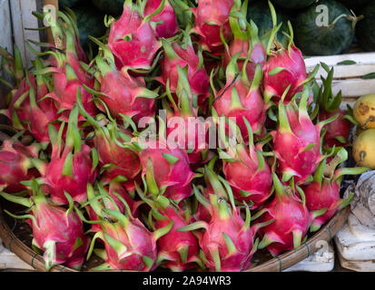 Close up of dragon fruit stacked on a bamboo platter at an outdoor market in Hoi An Vietnam. Stock Photo