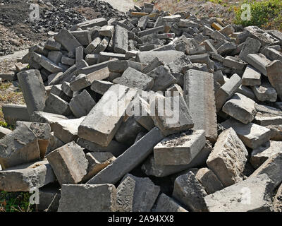 Large pile of old broken concrete blocks that were used in road pavement construction as a secondary raw materials Stock Photo