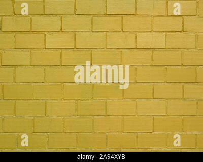 Brick wall painted in golden color as a background Stock Photo