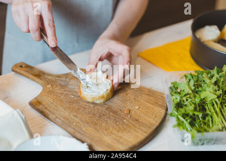 Pumpkin sandwiches with white cream cheese and green avocado on a fresh baguette - home recipe for making bruschetta Stock Photo