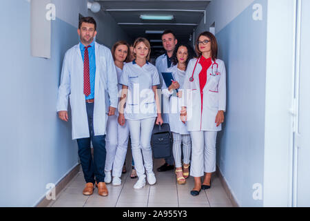 Group of medical staff, team doctors and nurses posing in the hallway of a hospital, clinic. Stock Photo