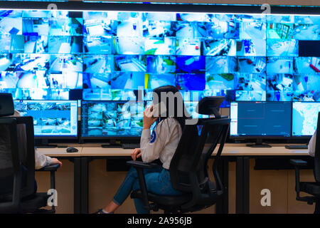 Team of secret agents in uniforms, monitoring cyber, video and communications at the main control data center station. Stock Photo