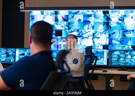 Team of secret agents in uniforms, monitoring cyber, video and communications at the main control data center station. Stock Photo