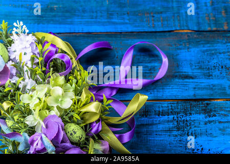 Easter background with boxwood and easter eggs on blue wood Stock Photo