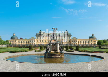 Drottningholm Palace, view in summer of Drottningholm Palace with the Baroque garden and Hercules Fountain in the foreground, Lovön island, Sweden. Stock Photo