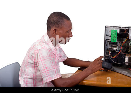 Young technician working on broken computer in his office Stock Photo
