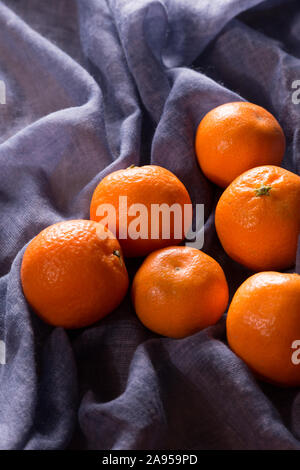 Tangerines or oranges, mandarins, clementines, citrus fruits on a blue napkin Stock Photo