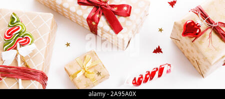 Christmas gift boxes with red and gold ribbons and candy canes, Stock Photo