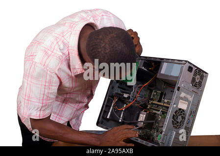 Young technician working on broken computer in his office Stock Photo