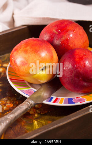 Fresh ripe tasty nectarines on the plate Stock Photo