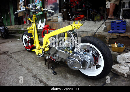 ANTIPOLO CITY, PHILIPPINES – NOVEMBER 8, 2019: Stripped down modified motorcycle at a garage. Stock Photo