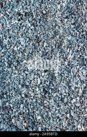 Small pebbles, granite marble stone chips, eco textured pedestrian paths. Pebble building material broken stone marble gray blue background backdrop t Stock Photo