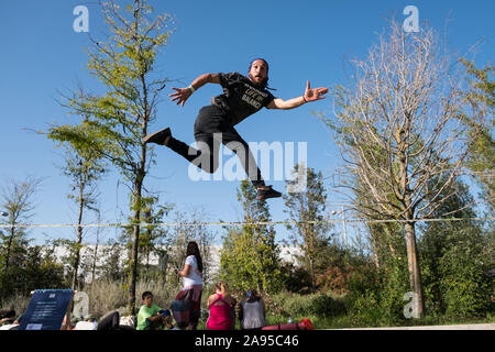 Young man jumping over a slackline at the Wanderlust festival, in Lisbon, Portugal. Stock Photo