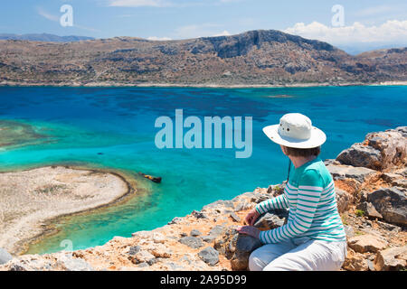 Imeri Gramvousa, Chania, Crete, Greece. Visitor admiring the view over Gramvousa Bay from ramparts of the Venetian fortress. Stock Photo