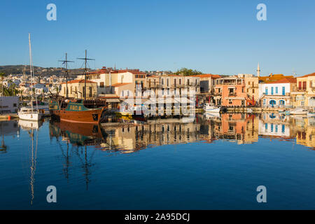 Rethymno, Crete, Greece. View across the Venetian Harbour at sunrise, colourful buildings reflected in water. Stock Photo