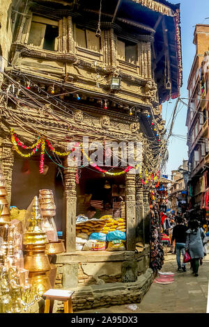 A vendor selling household wares and food stuff  in an old building at a corner of the old section of Thamel district in Kathmandu, Nepal Stock Photo