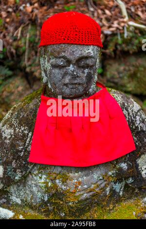 Jizo statues with red caps, protective deities for deceased children, Kanmangafuchi Abyss, Nikko, Japan Stock Photo