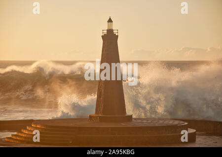 waves against the lighthouse Stock Photo