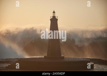 waves against the lighthouse Stock Photo