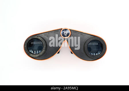 Vintage orange binoculars, made in Japan, isolated on white background, close-up Stock Photo