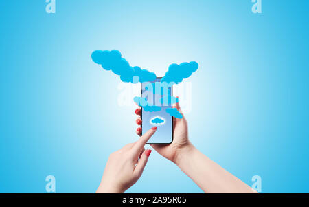 A Female is clicking on an app icon at her smart phone and lots of icons pop up from the screen. High resolution image with lots of copy space ready f Stock Photo