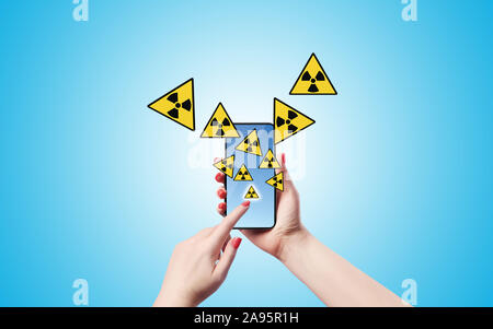 A Female is clicking on an app icon at her smart phone and lots of icons pop up from the screen. High resolution image with lots of copy space ready f Stock Photo