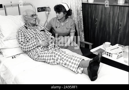 Nurse & elderly patient, Queen's Medical Centre, Nottingham UK March 1989 Stock Photo