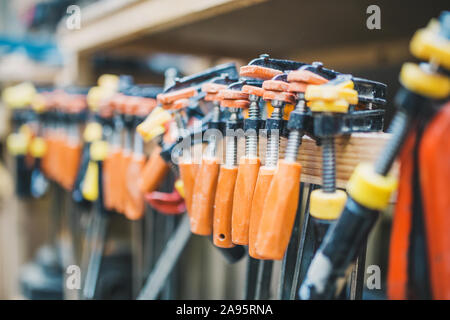 Carpentry workshop - a professional tool - a large set of clamps Stock Photo