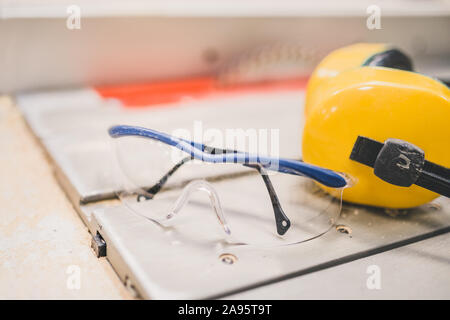 Carpentry workshop - protection of sight and hearing when working on machine tools in production Stock Photo