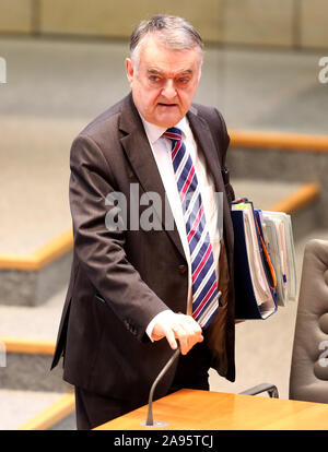 Duesseldorf, Germany. 13th Nov, 2019. The North Rhine-Westphalian Interior Minister Herbert Reul (CDU) comes with documents to his workplace in the plenary hall. The topics of the session of the North Rhine-Westphalian state parliament include the environment and education. Credit: Roland Weihrauch/dpa/Alamy Live News Stock Photo