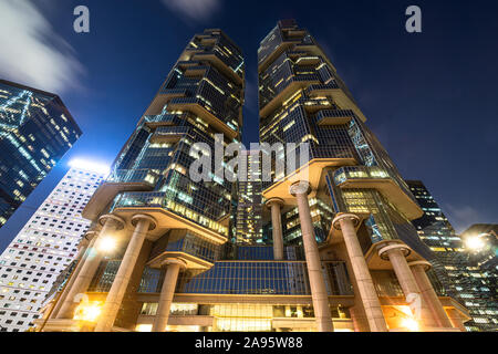 Low angle view of modern skyscrapers in the Central business district in Hong Kong island at night in Hong Kong SAR, China Stock Photo