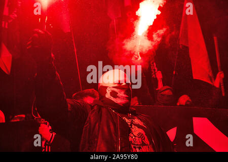 Marchers burn flares as they take part in the annual March of Independence organized by far right activists to celebrate 101 years of Poland's indepen Stock Photo