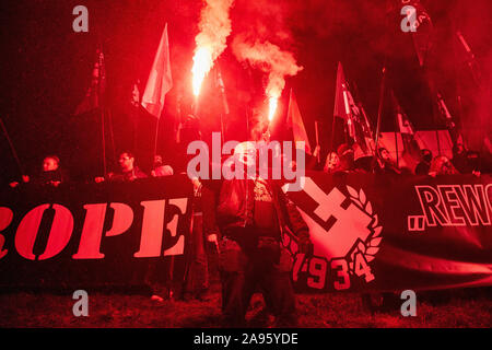 Marchers burn flares as they take part in the annual March of Independence organized by far right activists to celebrate 101 years of Poland's indepen Stock Photo