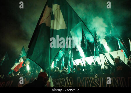 Marchers burn flares as they take part in the annual March of Independence organized by far right activists to celebrate 101 years of Poland's indepen Stock Photo