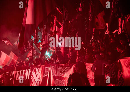 Marchers burn flares as they take part in the annual March of Independence organized by far right activists to celebrate 101 years of Poland's indepen Stock Photo