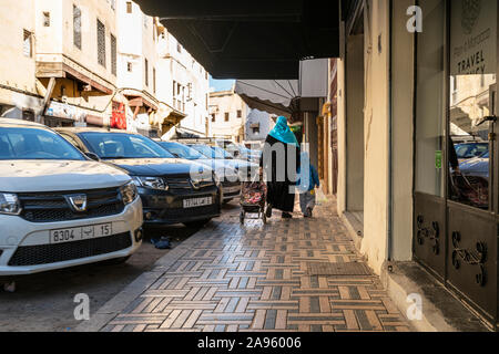 Fez, Morocco. November 9, 2019.  a woman with her child in a city center street Stock Photo