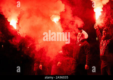 Marchers burn flares as they take part in the annual March of Independence organized by far right activists to celebrate 101 years of Poland's indepen Stock Photo