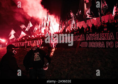 Marchers burn flares as they take part in the annual March of Independence organized by far right activists to celebrate 101 years of Poland's indepen Stock Photo