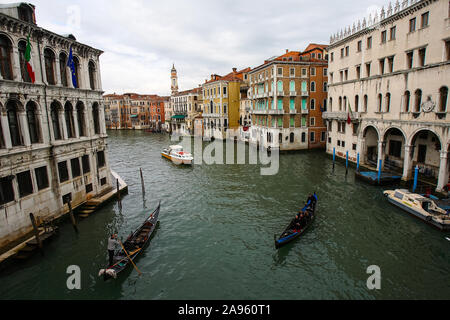 Venice, Italy, February 5, 2008: Gondoliers row their gondolas full of tourists through a channel in Venice, Italy. Stock Photo