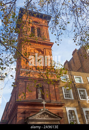 London, City of Westminster.  The red-brick tower of late Victorian St Patrick's Roman Catholic church in Soho Square. Stock Photo