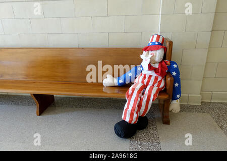 Life Size Uncle Sam American Fabric Doll Figure Sat On A Wooden Bench During Voting In The Old Volusia Courthouse DeLand Florida USA Stock Photo