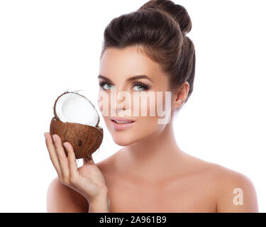 Portrait of beautiful young woman with a coconut in the studio Stock Photo